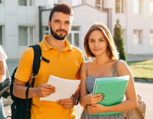 Dos jóvenes universitarios con sus bolsos y elementos de estudio.